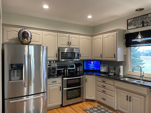 Cabinets painted a beige color with black handles in a Omaha Kitchen.