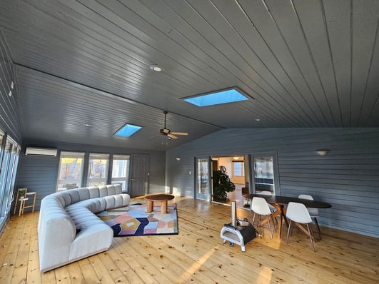 Sunroom with a dark grey shade on the ceiling and walls in a house in Omaha.