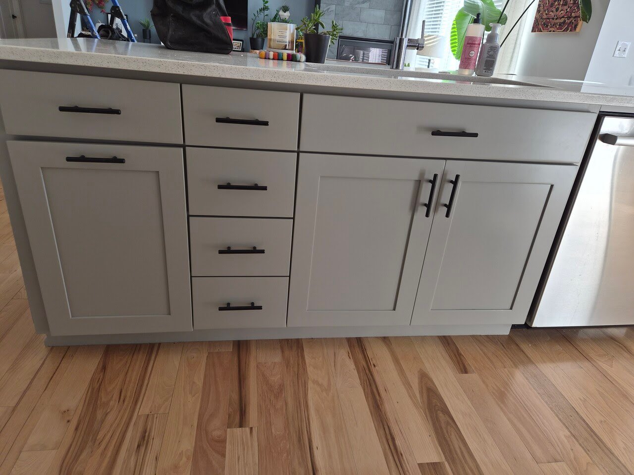 Cabinets painted a cool brown color with black handles.