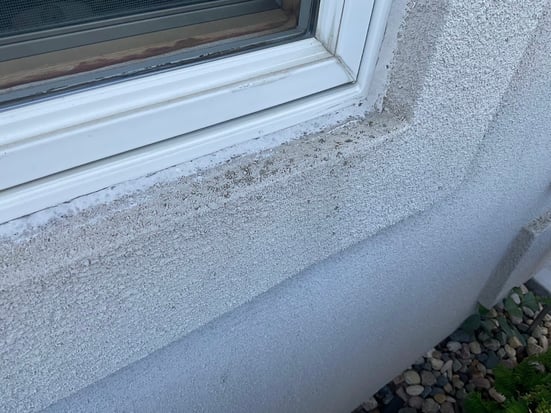 EIFS around the window on the exterior of a house chipping.