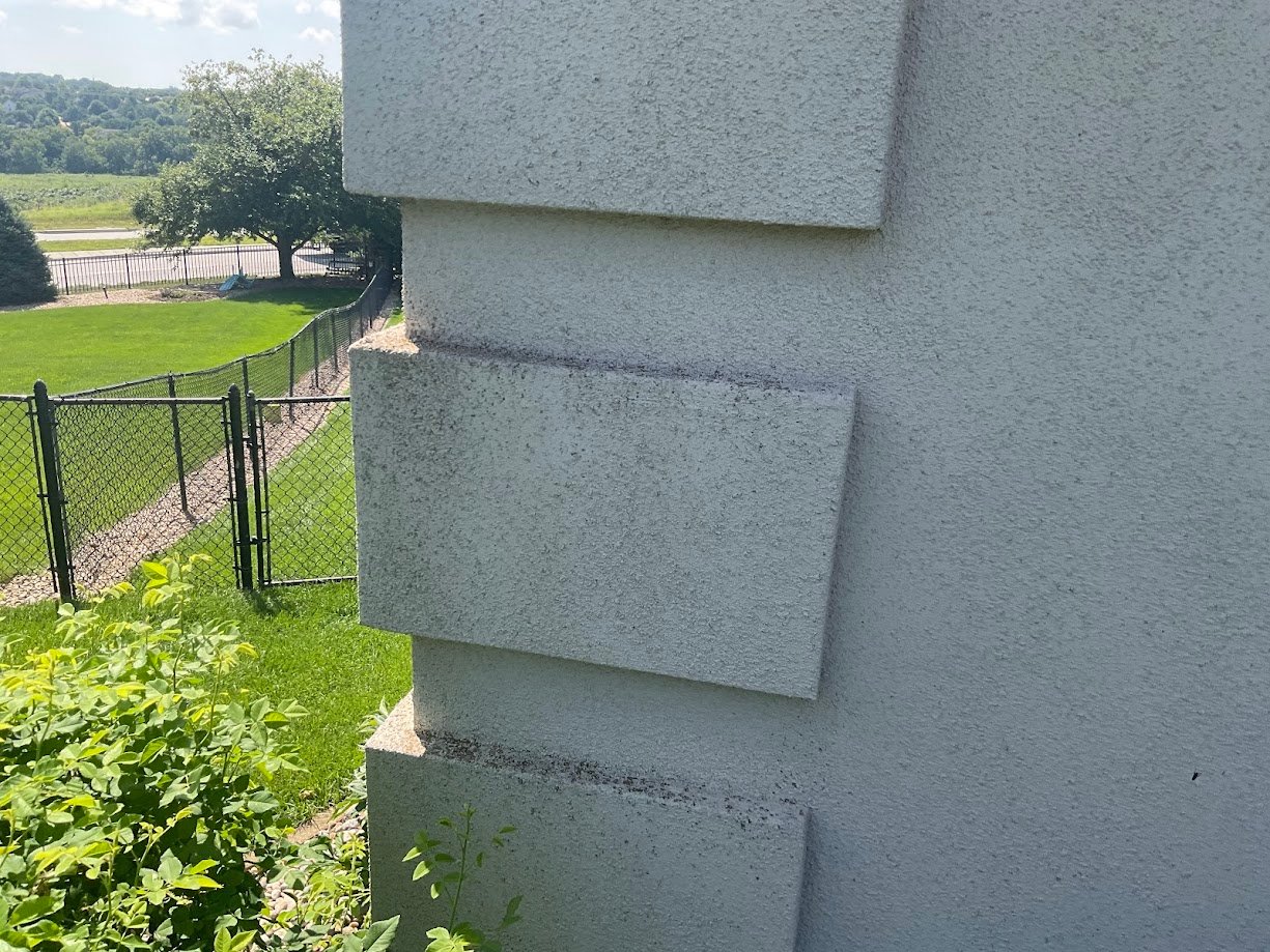 Concrete EIFS synthetic stucco blocks on the corner of a home in Omaha, NE before painting.