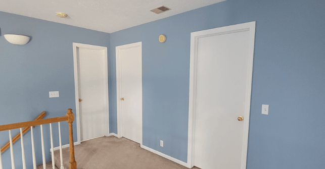 Light blue paint color on walls with white trim and doors.