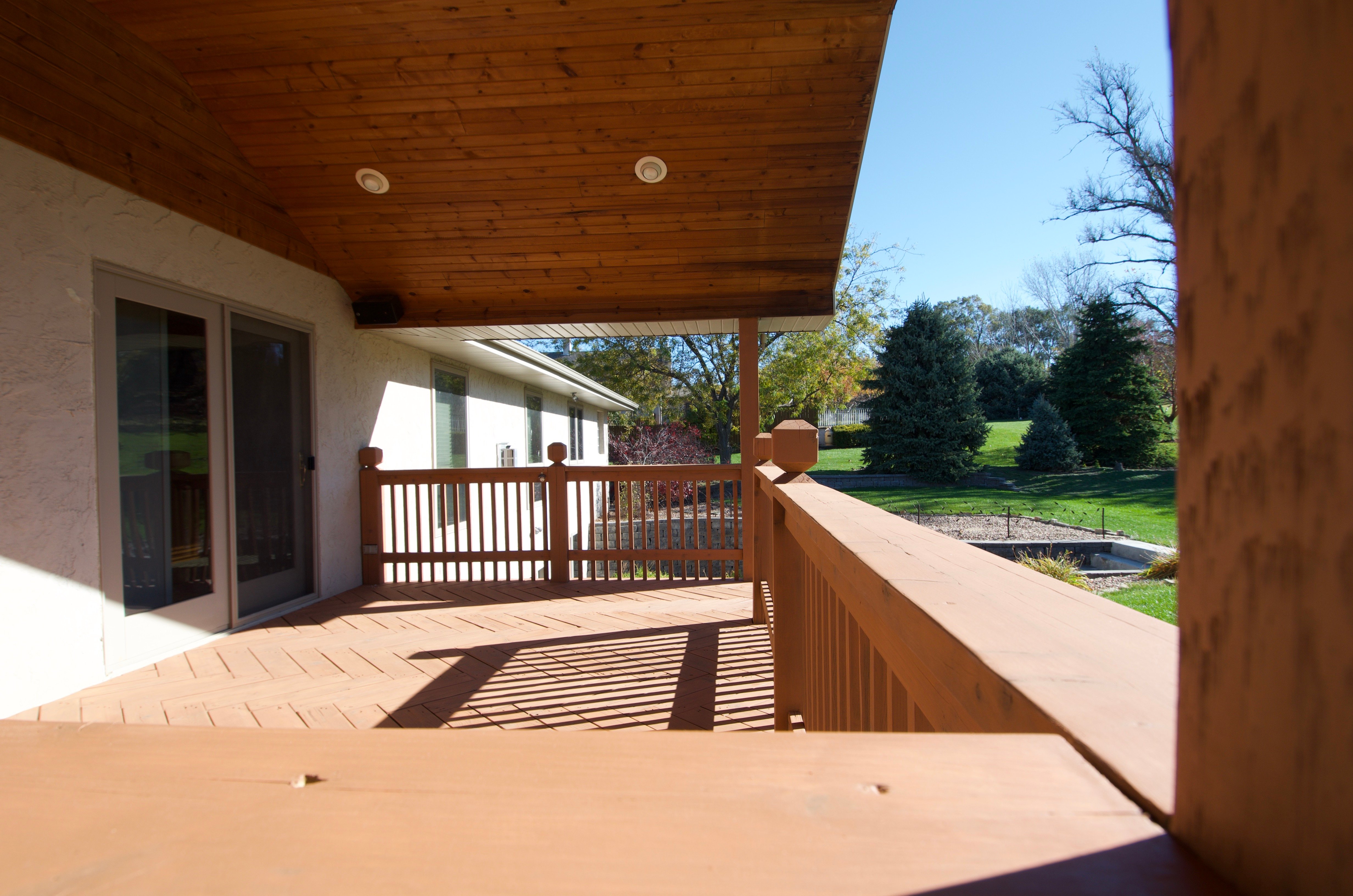 Wood deck stained a warm orangish brown color in Omaha, NE.