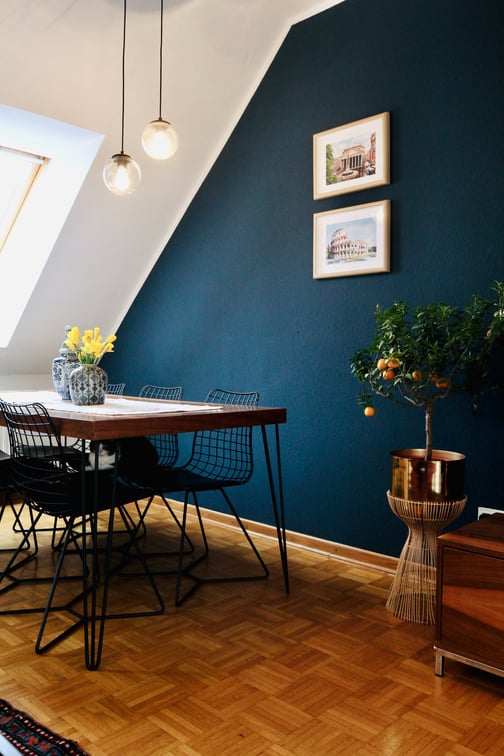 Dining room with dark blue accent wall