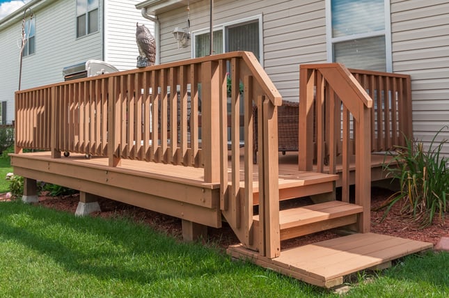 Wood deck freshly stained a warm light orangey brown color in Omaha, NE.