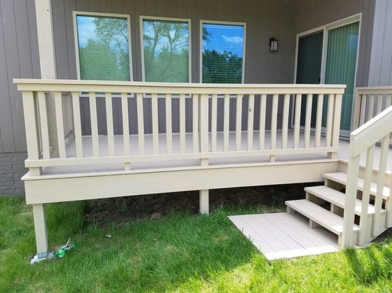 Small deck with white solid color stain and a few steps.