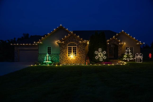 House lit up with add on options and decorations on the outside of a house in Omaha, NE.