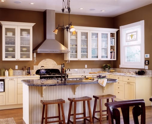 Brown kitchen walls with white cabinets