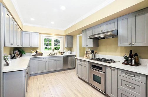 Gray kitchen cabinets with yellow walls