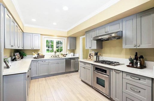 Gray kitchen cabinets with yellow walls