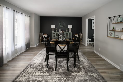 Dining room with back wall painted black.