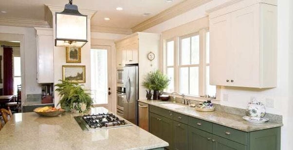 Kitchen with white upper cabinets and green painted lower cabinets