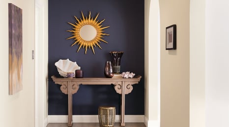 Entryway of home with dark blue navy accent wall.