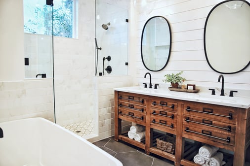 White painted bathroom with black and dark wood accents.