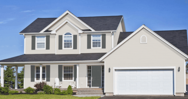 Exterior of house with beige paint on siding, white paint on trim and garage doors, and dark green grey shutters.