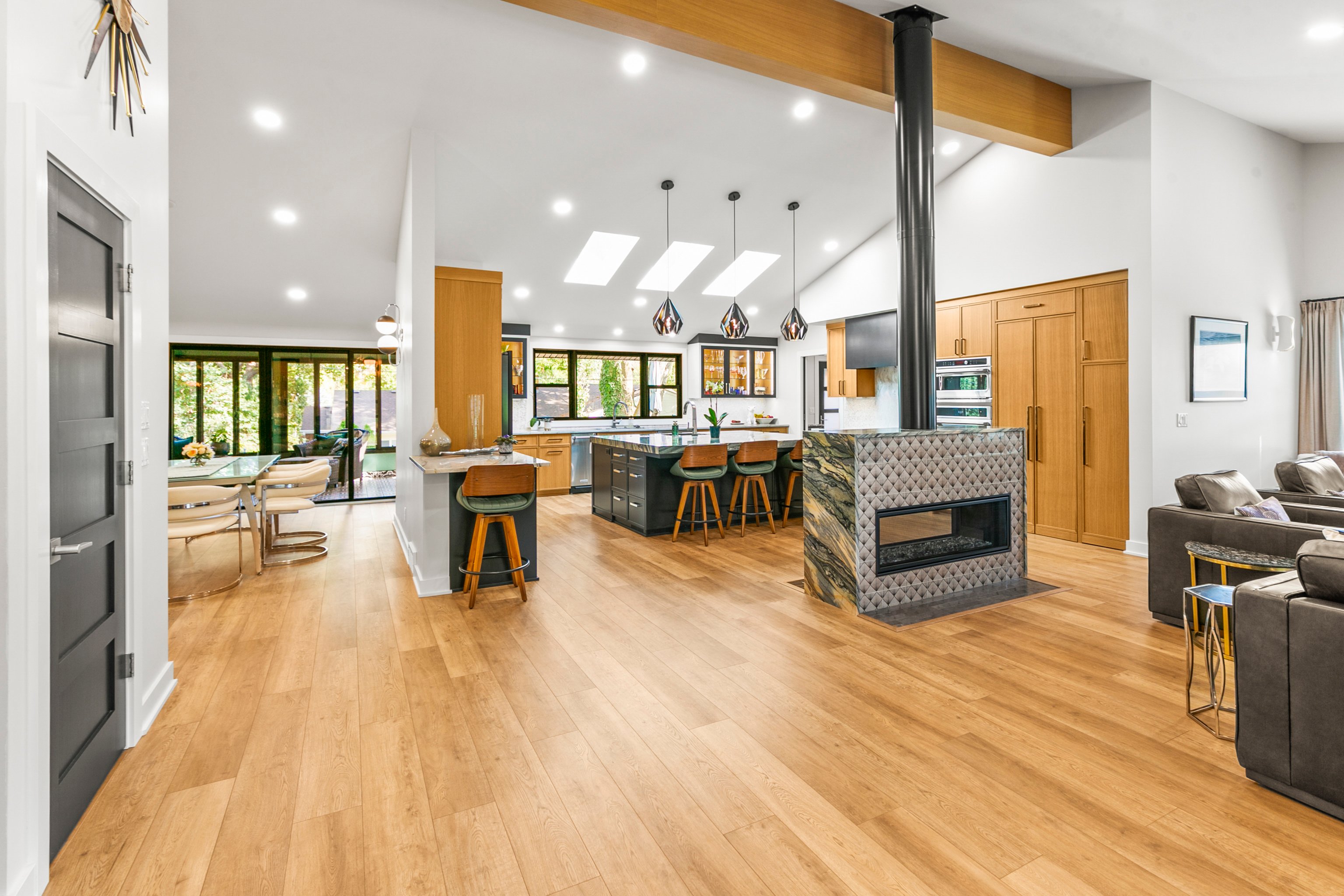 Kitchen with warm wood floors and cabinets and walls and ceilings painted white in Omaha.