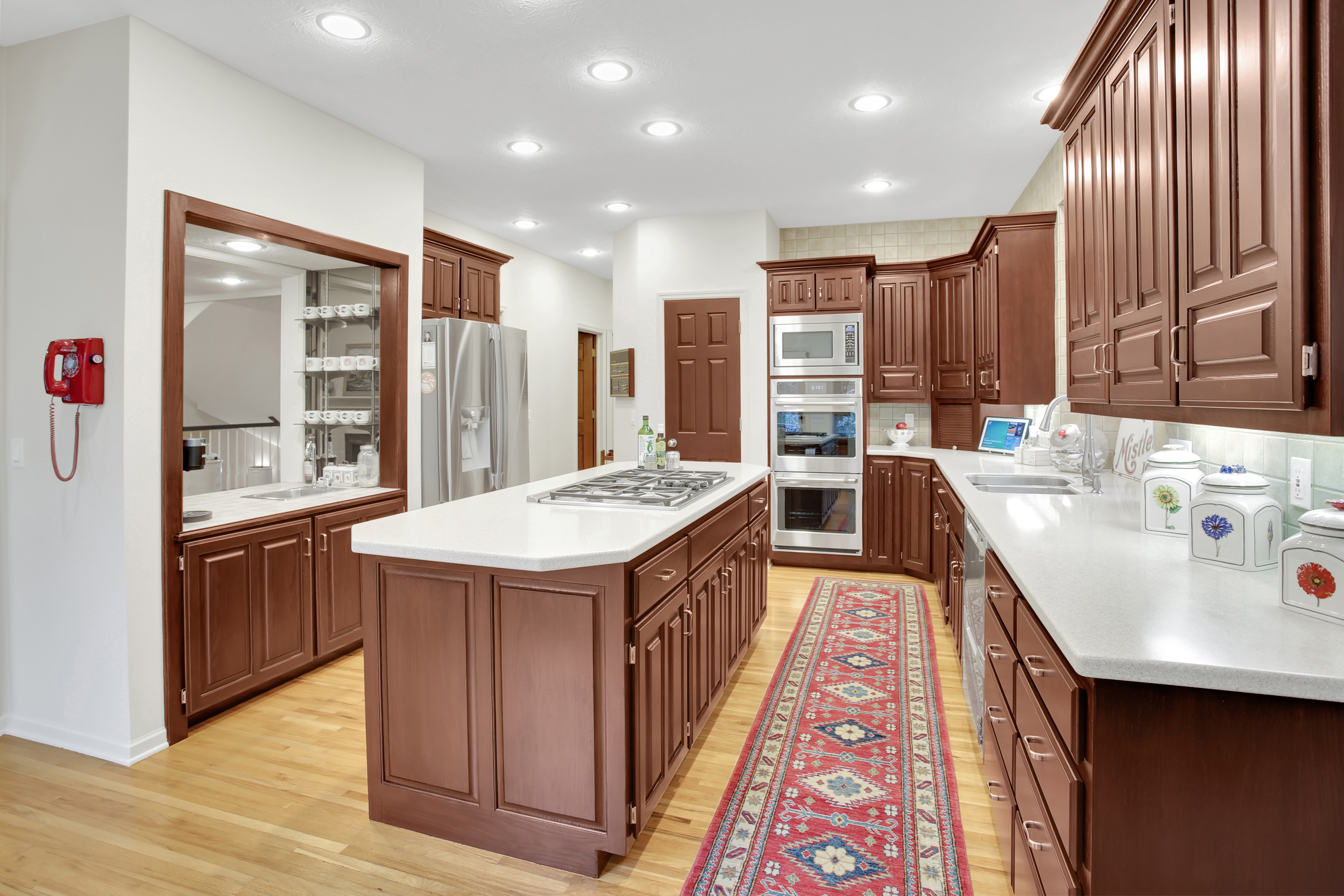 Large kitchen with warm brown toned cabinets.