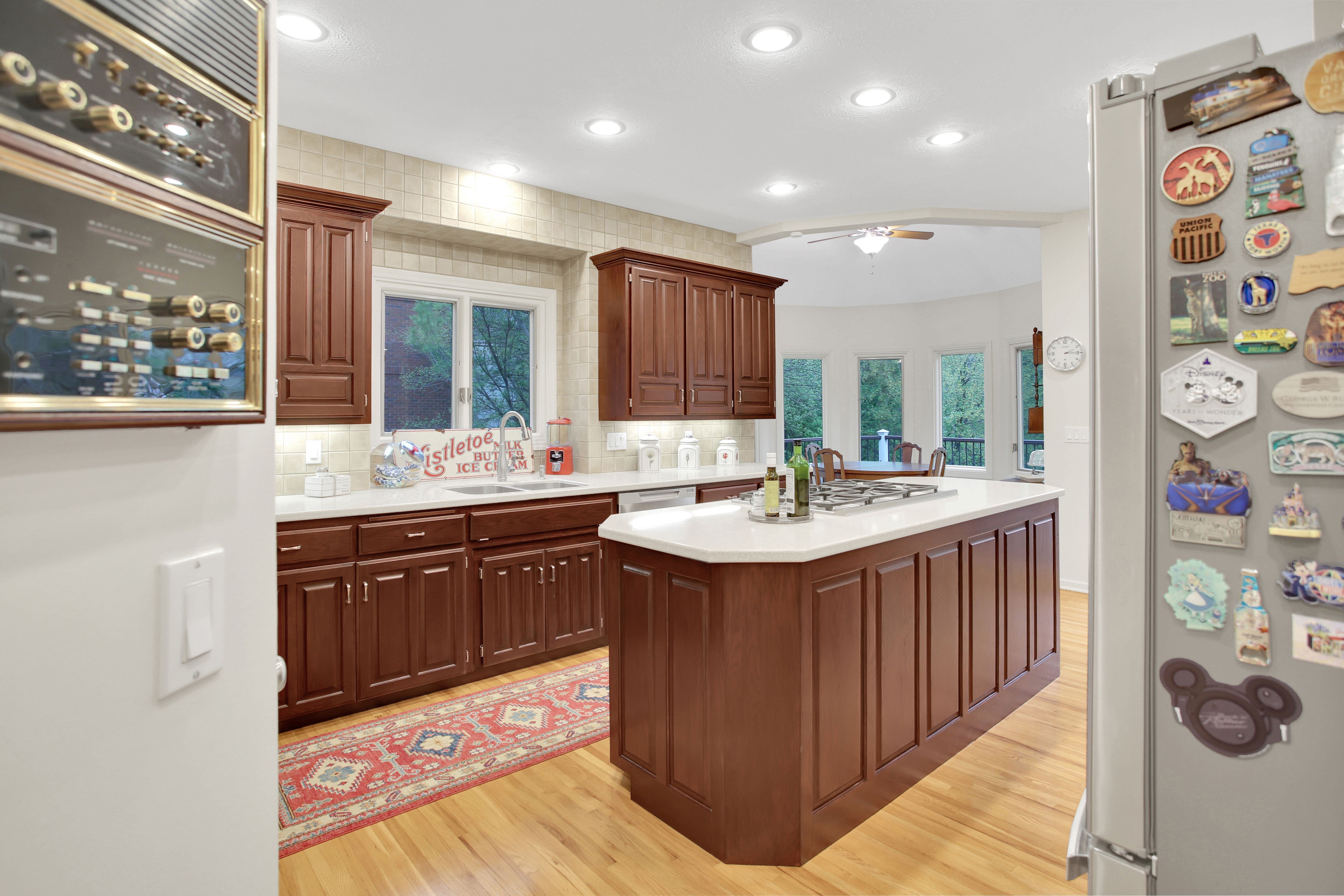 Kitchen cabinets stained brown with white countertops and walls.