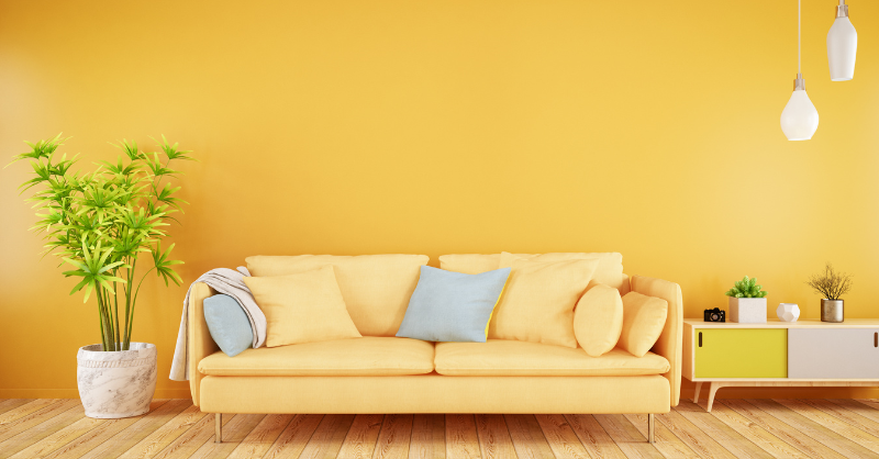 Living room with bright yellow walls and yellow couch.