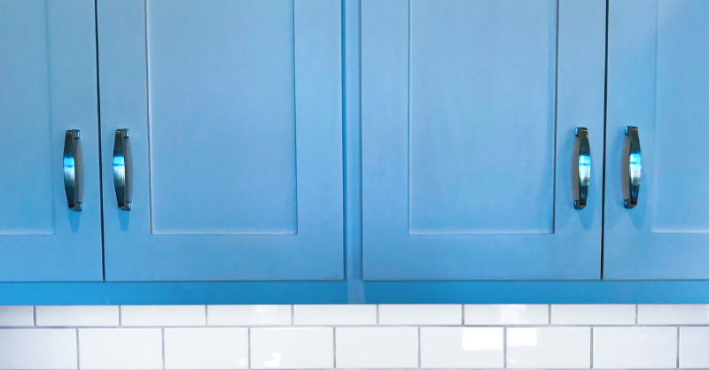 Upper kitchen cabinets painted blue.