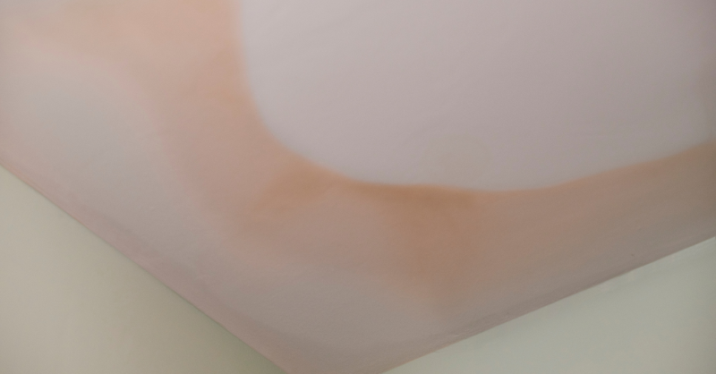 White ceiling with yellow, orangish stains around the outside.