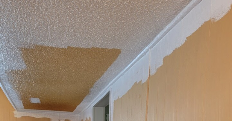 Textured ceiling and walls in room being painted white over beige/yellow color.