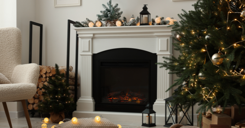 Wood fireplace and mantle painted white and decorated for Christmas.