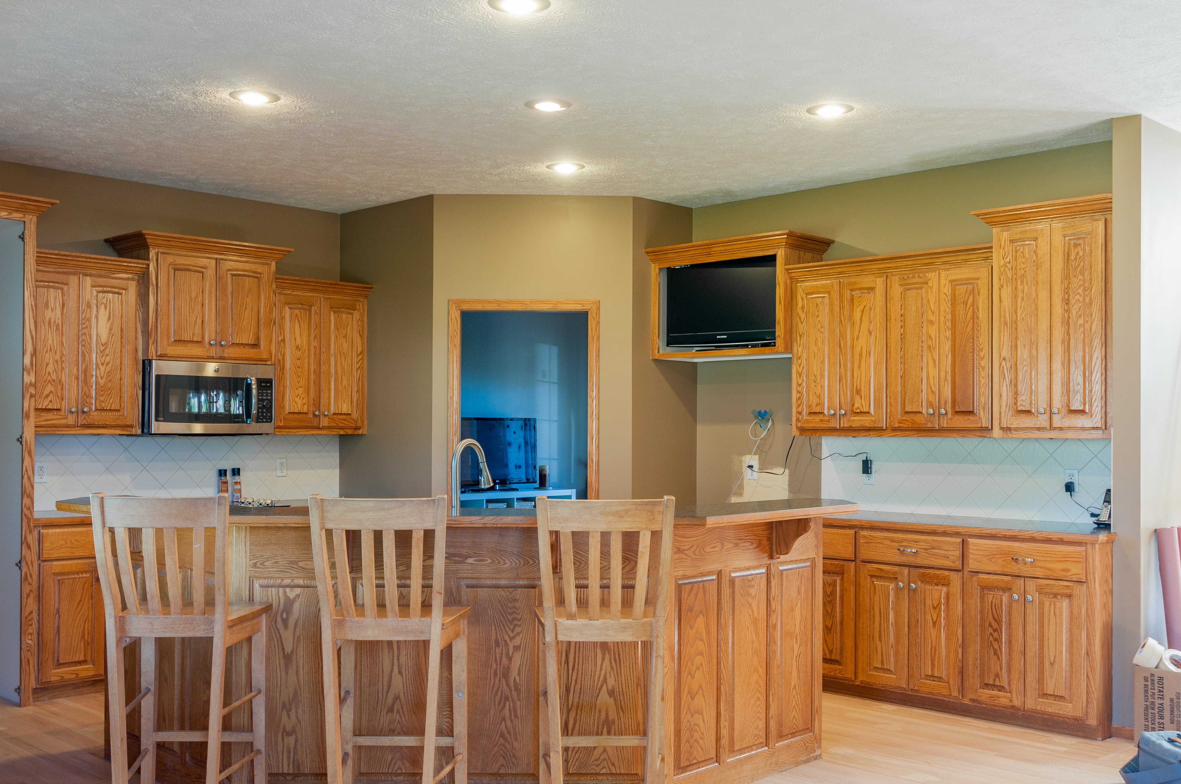 Kitchen cabinets and island with refinished oak wood. 