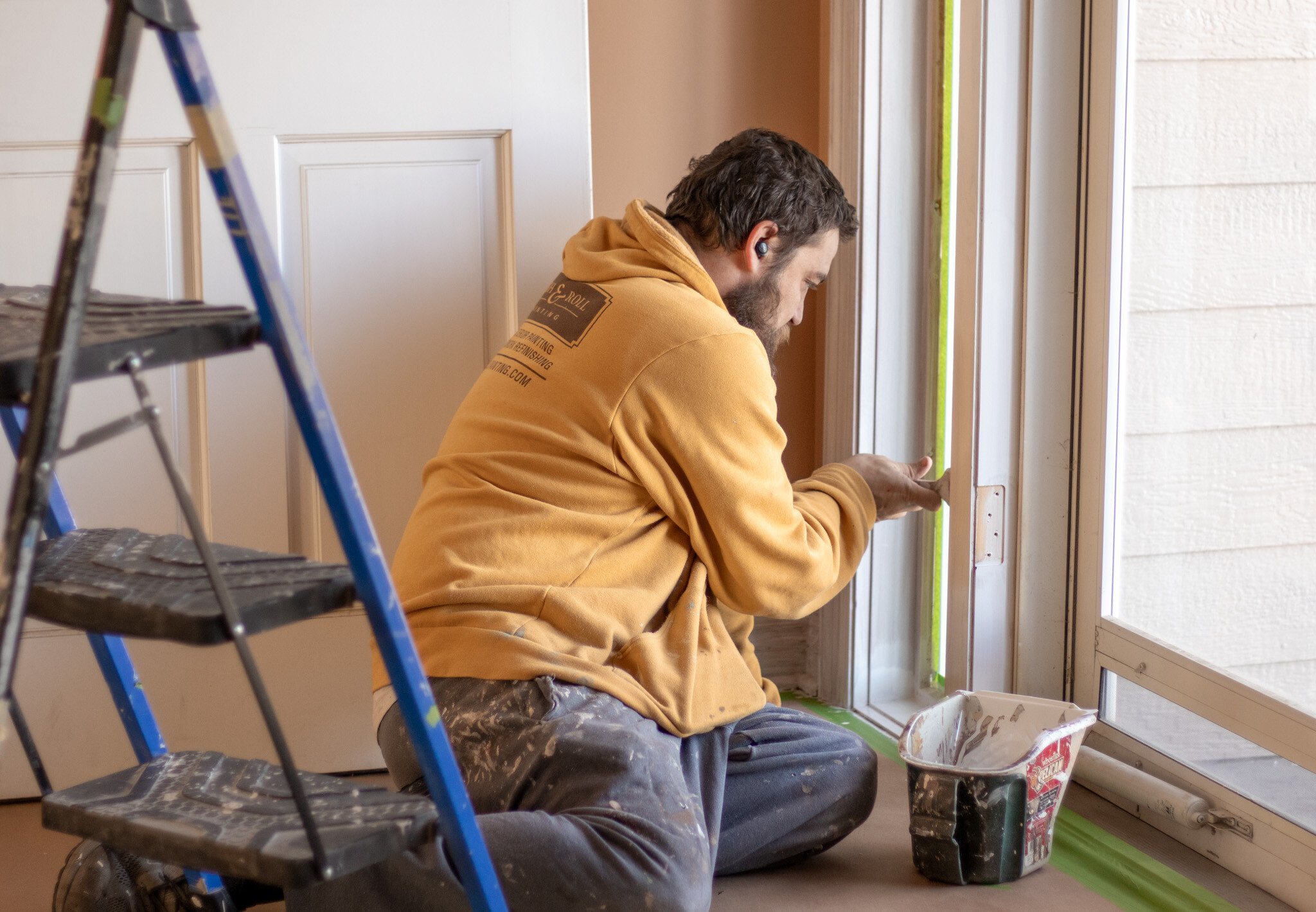 Brush & Roll Painting interior painter painting door trim white in a home in Omaha, NE.