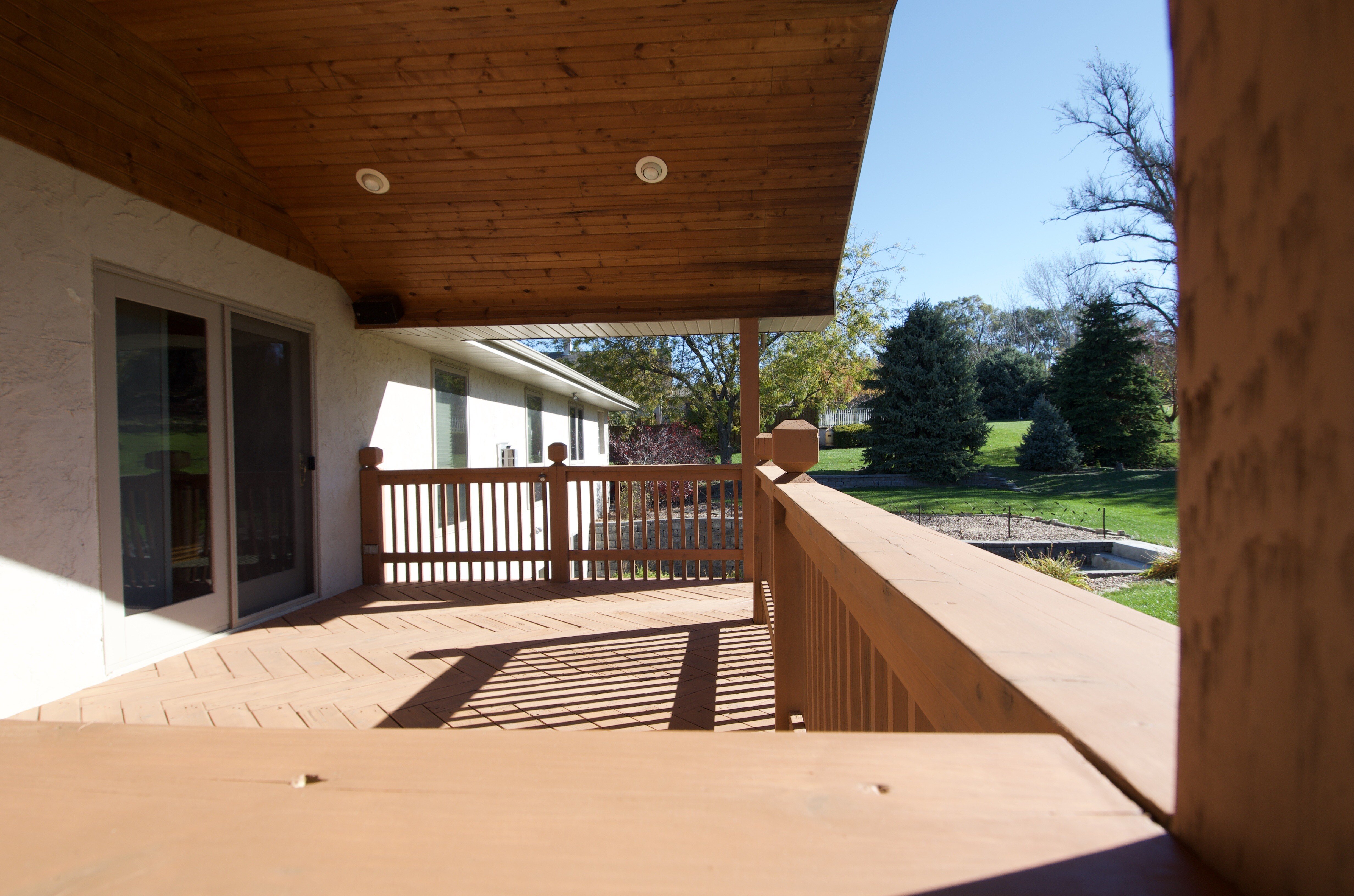 Wooden deck after being stained with a warm light wooden color.