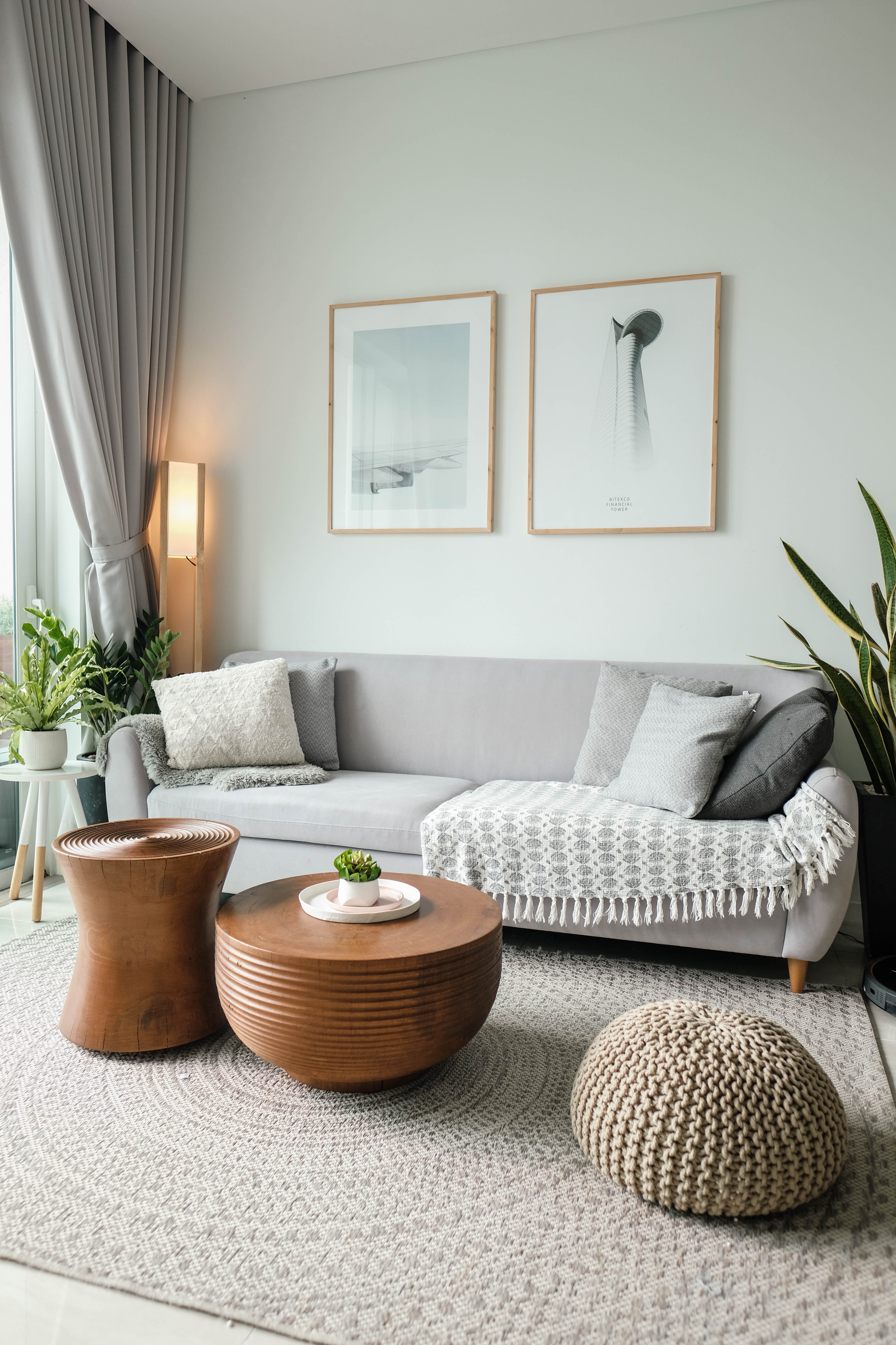 Light neutral living room with a gray couch and white walls.